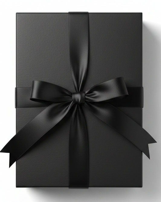 A matte black rectangular gift box tied with a matching black satin ribbon and bow, shown from a top-down view on a white background with a soft shadow.
